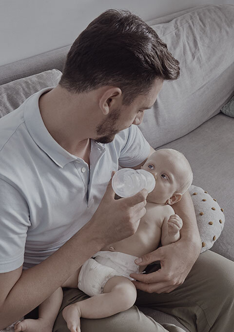 Dad is feeding his baby.