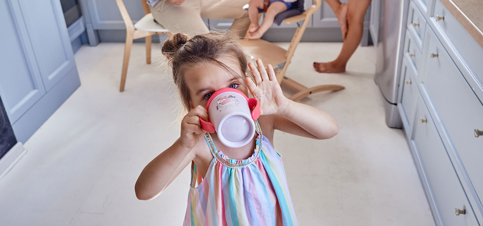 Girl about a 4 years old, drinking from a LOVI 360 Cup.