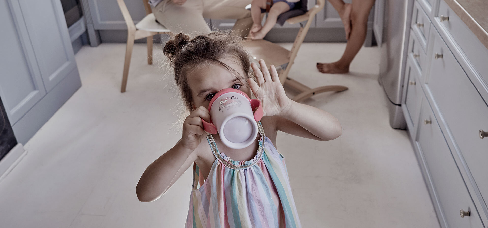 Girl about a 4 years old, drinking from a LOVI 360 Cup.