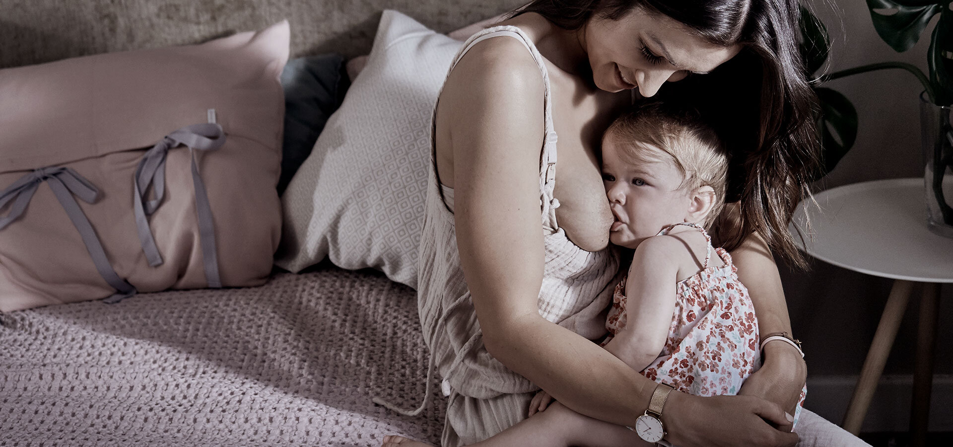 Woman breastfeeding a small baby girl.